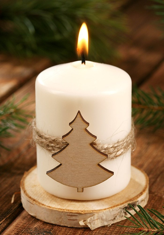 Christmas candle Candle with a Christmas tree on natural wood